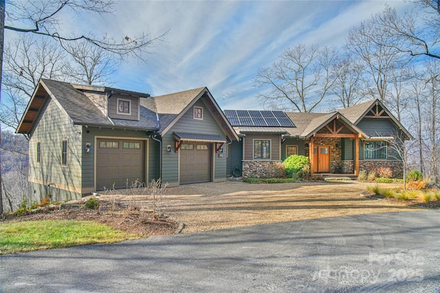 craftsman house featuring a garage and solar panels