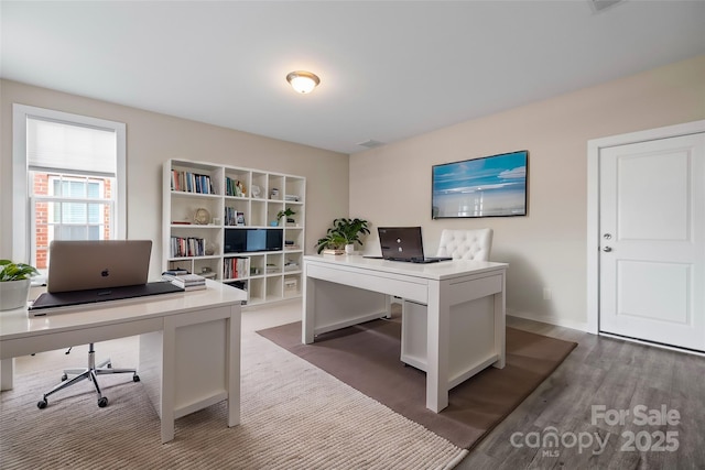 office space with dark wood-type flooring