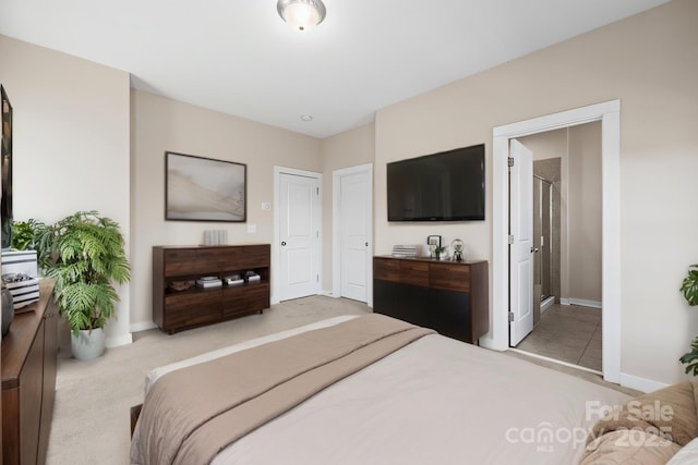 carpeted bedroom featuring baseboards