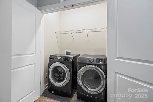 clothes washing area featuring laundry area and washing machine and clothes dryer