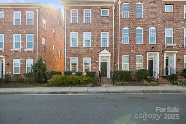 townhome / multi-family property with brick siding