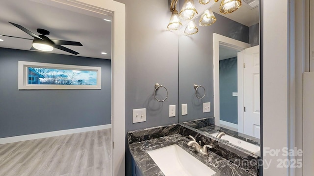 bathroom with vanity, hardwood / wood-style floors, and ceiling fan