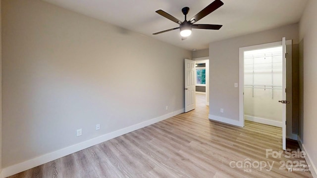 unfurnished bedroom featuring ceiling fan, a closet, and light wood-type flooring