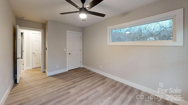 unfurnished bedroom with light hardwood / wood-style floors and ceiling fan