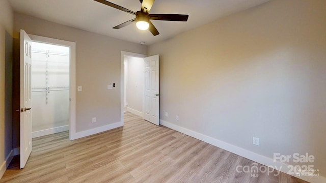 unfurnished bedroom featuring a closet, ceiling fan, and light wood-type flooring