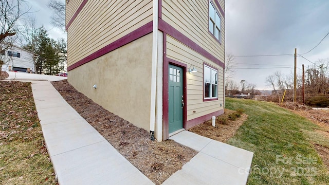 view of side of home featuring a lawn