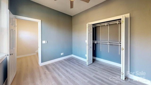 unfurnished bedroom featuring light hardwood / wood-style flooring, ceiling fan, and a closet