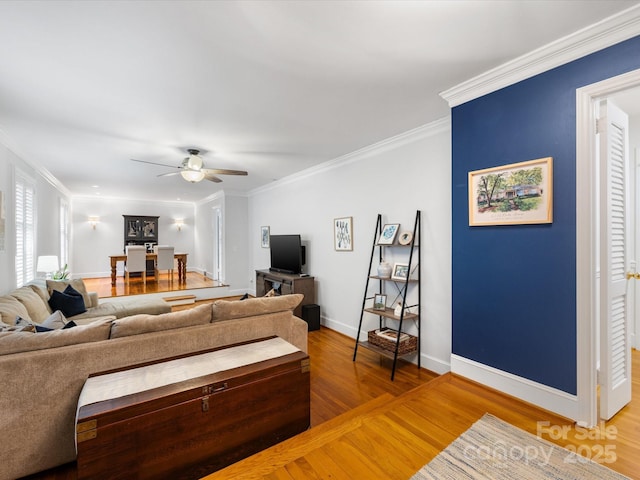 living room featuring crown molding, ceiling fan, and hardwood / wood-style floors