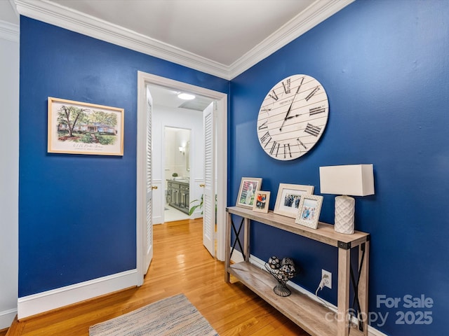 corridor featuring ornamental molding and hardwood / wood-style floors