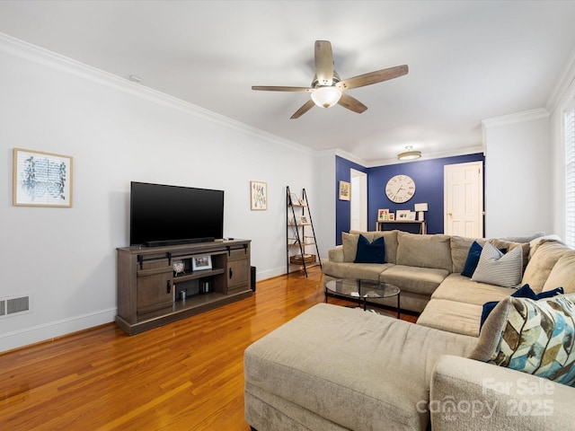 living room with ceiling fan, ornamental molding, and light wood-type flooring