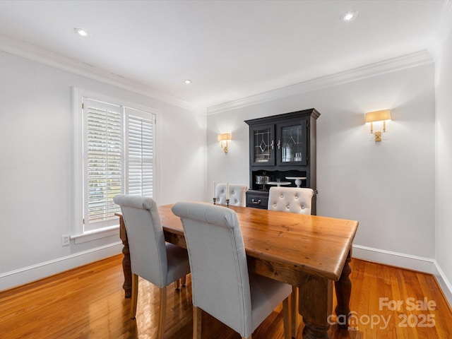 dining space with crown molding and dark hardwood / wood-style floors