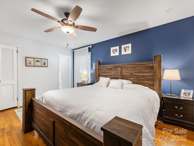 bedroom with ceiling fan and light hardwood / wood-style floors