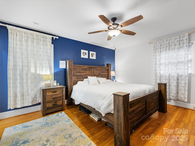 bedroom featuring hardwood / wood-style flooring and ceiling fan