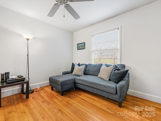 living room featuring ceiling fan and light wood-type flooring