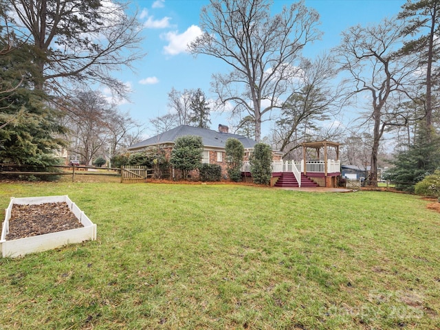 view of yard featuring a wooden deck