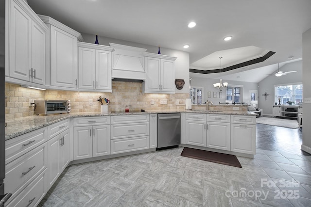 kitchen featuring dishwasher, white cabinetry, tasteful backsplash, custom exhaust hood, and kitchen peninsula