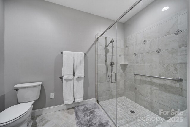 bathroom with walk in shower and toilet