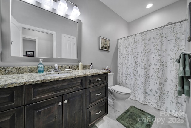 bathroom featuring vanity, toilet, and walk in shower