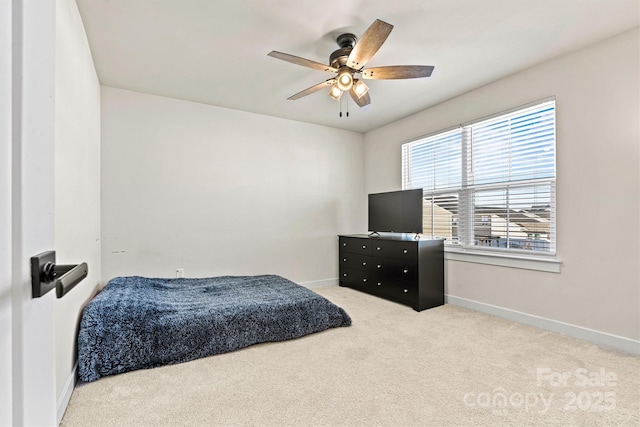 bedroom featuring ceiling fan and light carpet