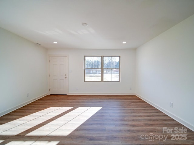 spare room with hardwood / wood-style flooring