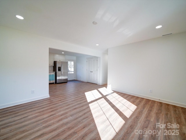 unfurnished living room featuring hardwood / wood-style flooring