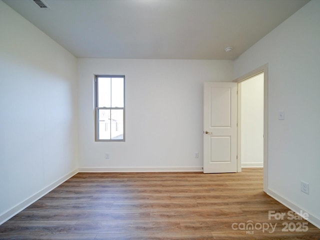 unfurnished room featuring wood-type flooring