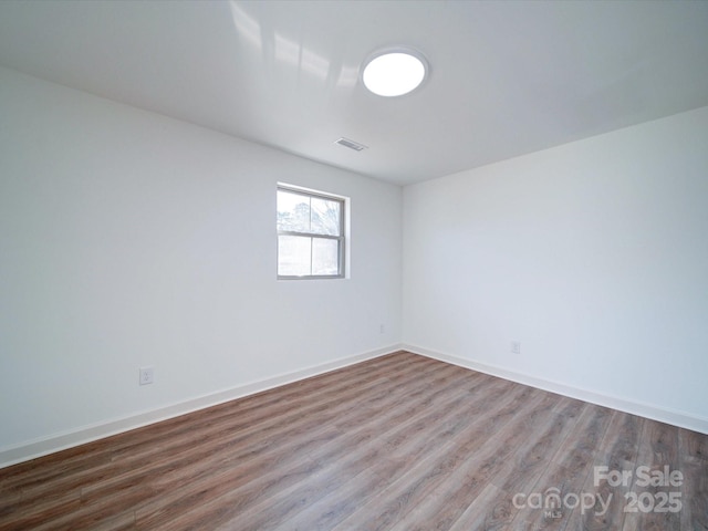 spare room with hardwood / wood-style flooring