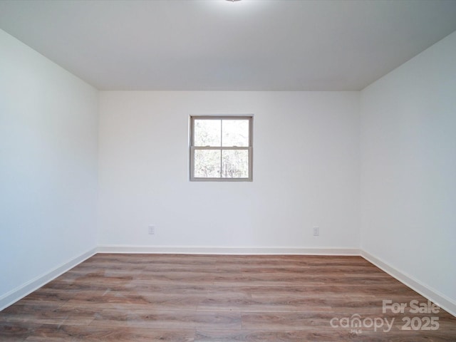 unfurnished room featuring hardwood / wood-style flooring