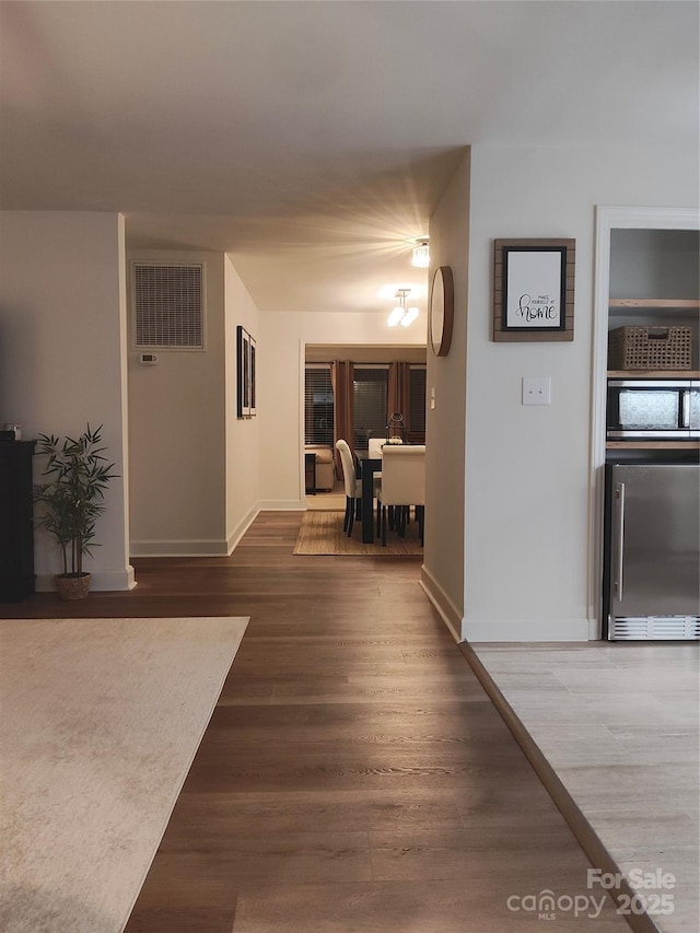 corridor with wood-type flooring