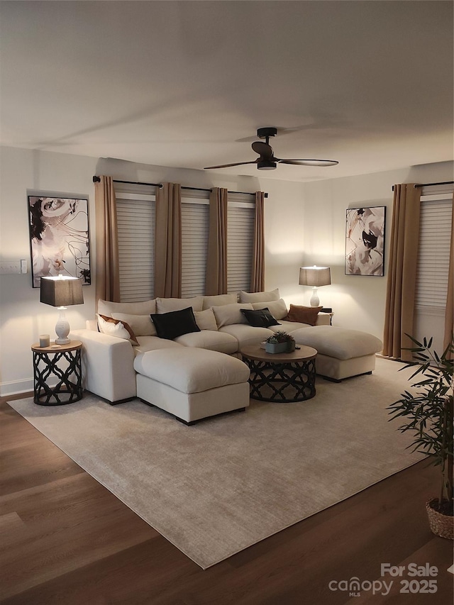 living room featuring wood-type flooring and ceiling fan