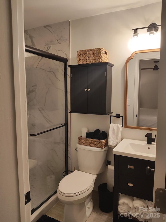 bathroom with walk in shower, vanity, and toilet