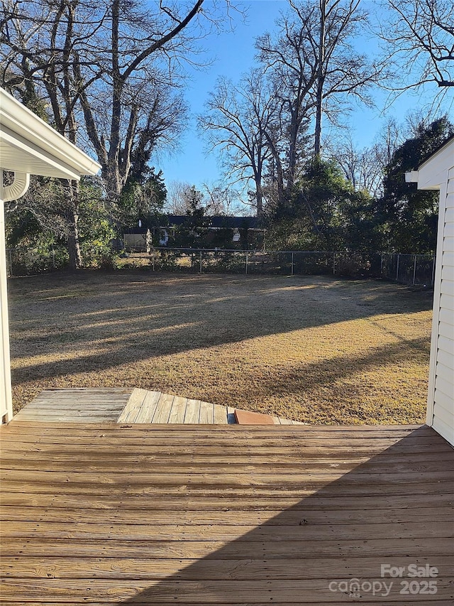 wooden deck featuring a yard