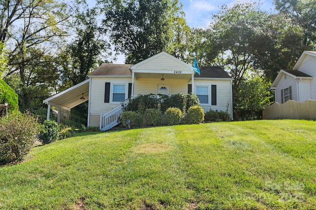 view of front facade with a front lawn and a carport