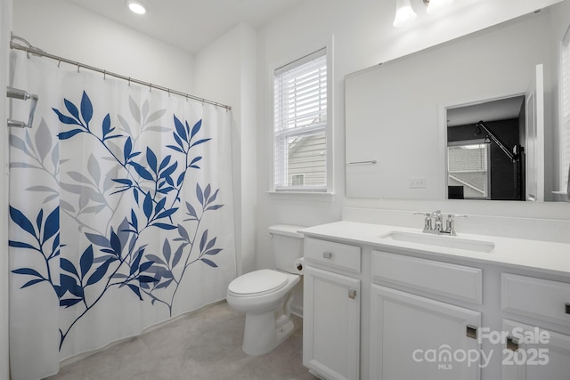 bathroom featuring vanity and toilet