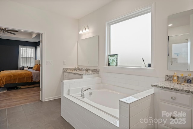 bathroom featuring vanity, tile patterned floors, ceiling fan, and plus walk in shower