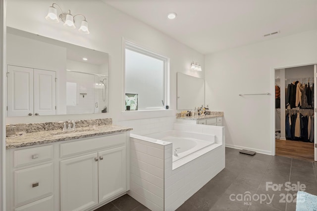 bathroom with independent shower and bath, vanity, and tile patterned floors