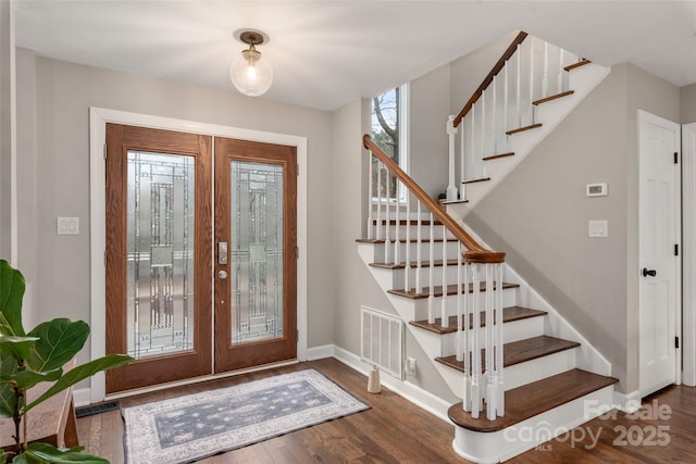 foyer entrance with dark hardwood / wood-style flooring and french doors