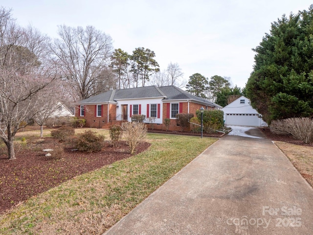 ranch-style home with an outbuilding, a garage, and a front yard