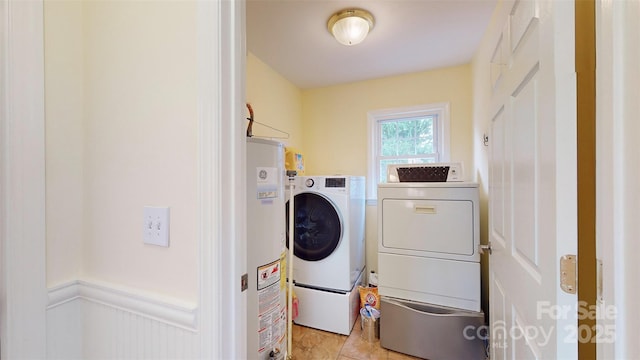 washroom with light tile patterned flooring, washing machine and clothes dryer, and gas water heater