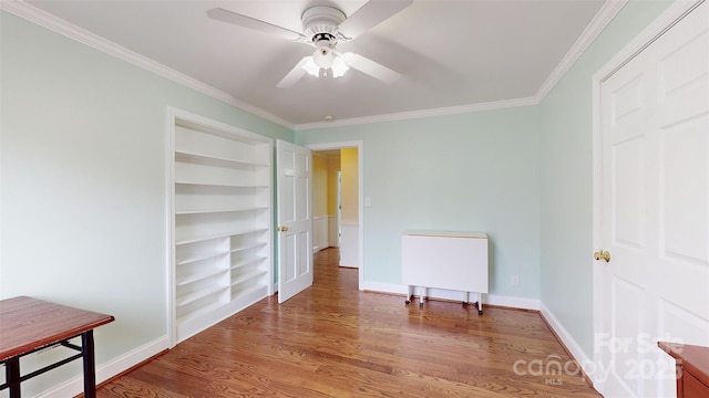 bedroom with ornamental molding, wood-type flooring, and ceiling fan