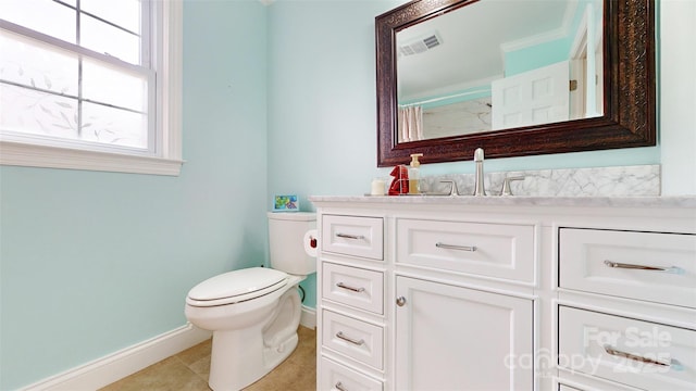 bathroom featuring vanity, tile patterned floors, and toilet