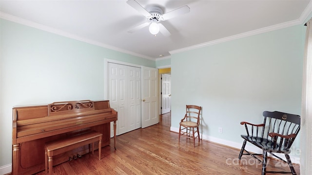 sitting room featuring crown molding, ceiling fan, and hardwood / wood-style floors