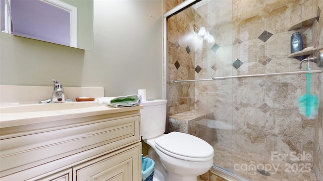 bathroom featuring vanity, an enclosed shower, and toilet