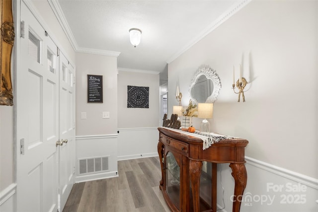 hallway featuring crown molding and wood-type flooring