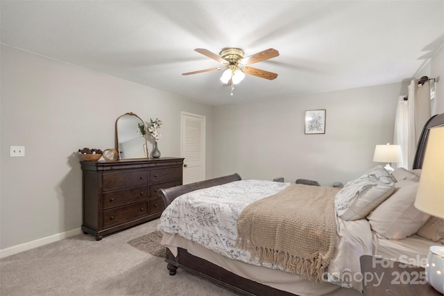 bedroom featuring light colored carpet and ceiling fan