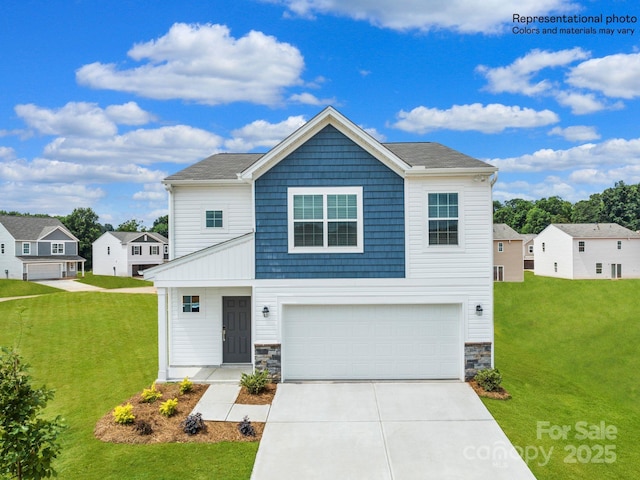 view of front of property featuring a garage and a front lawn