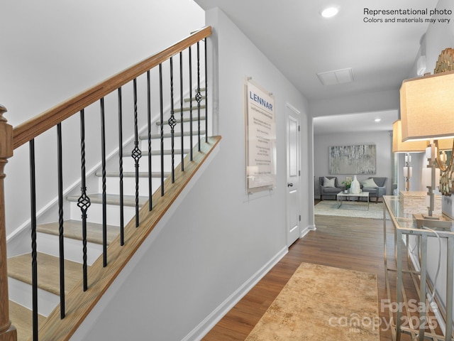 staircase with hardwood / wood-style flooring