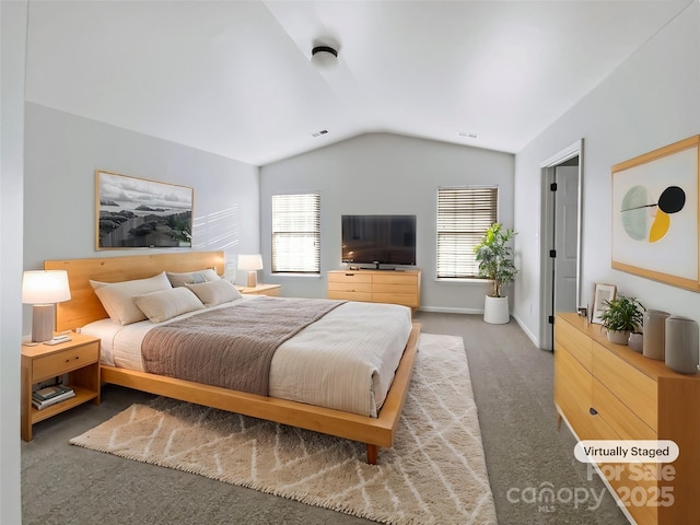 bedroom with vaulted ceiling and dark colored carpet