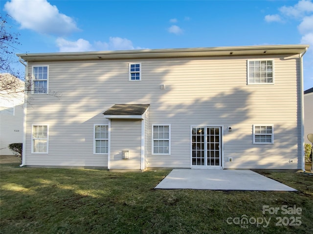 back of property with a patio area and a lawn