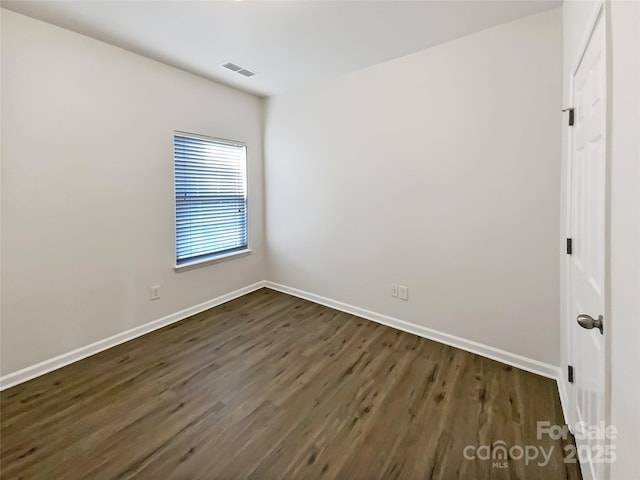 unfurnished room featuring dark wood-type flooring